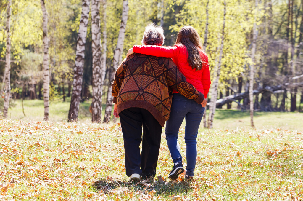 lady walking in the park with mum with Dementia