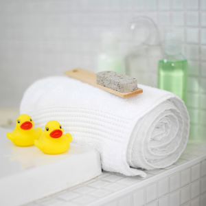rubber ducks, towel, pumice and shower gels on the bathroom side