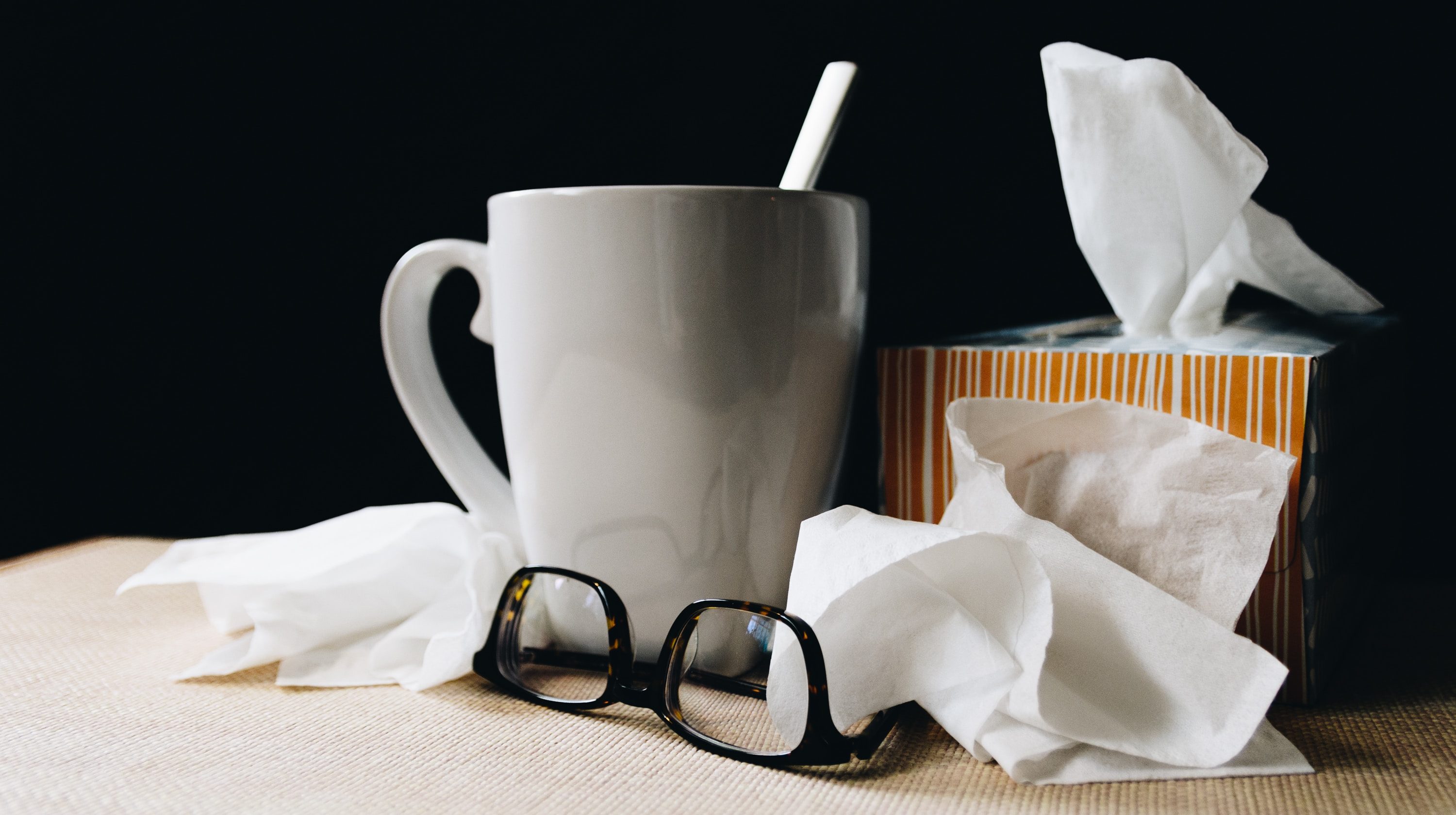 mug and tissues on table