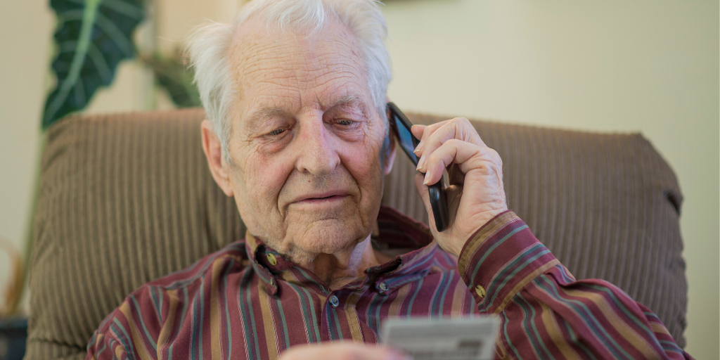 Elderly man telephone scam reading out his card details