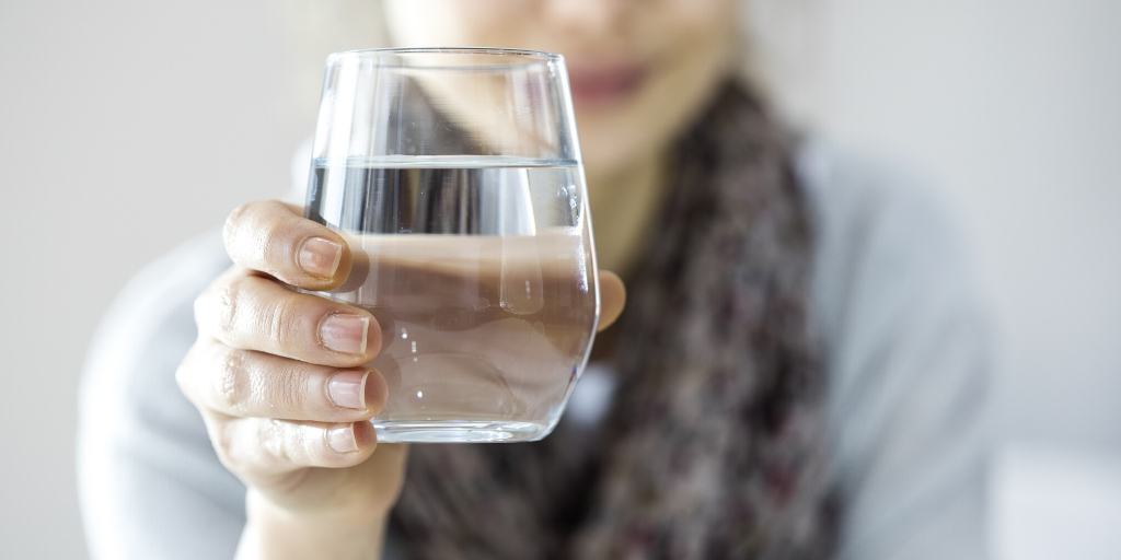 lady offering a glass of water