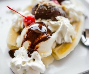 Delicious Summer Meal Ideas banana split with ice cream cream chocolate sauce and a cherry